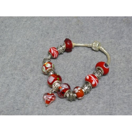 67 - A LOVELY RED AND WHITE CHARM BRACELET WITH GLASS BEADS MARKED 925