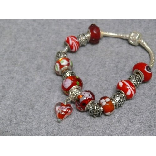 67 - A LOVELY RED AND WHITE CHARM BRACELET WITH GLASS BEADS MARKED 925