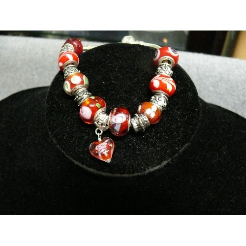 67 - A LOVELY RED AND WHITE CHARM BRACELET WITH GLASS BEADS MARKED 925