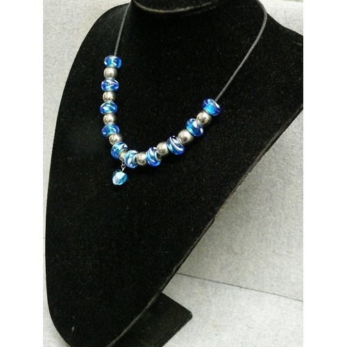 68 - A LOVELY BLUE AND WHITE CHARM NECKLACE WITH GLASS BEADS MARKED 925