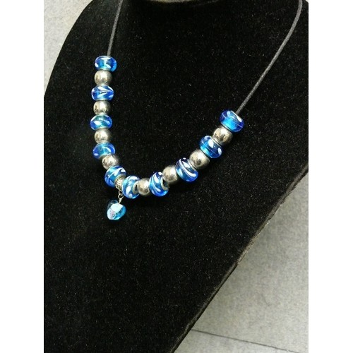 68 - A LOVELY BLUE AND WHITE CHARM NECKLACE WITH GLASS BEADS MARKED 925