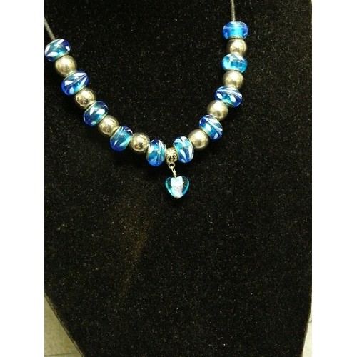 68 - A LOVELY BLUE AND WHITE CHARM NECKLACE WITH GLASS BEADS MARKED 925