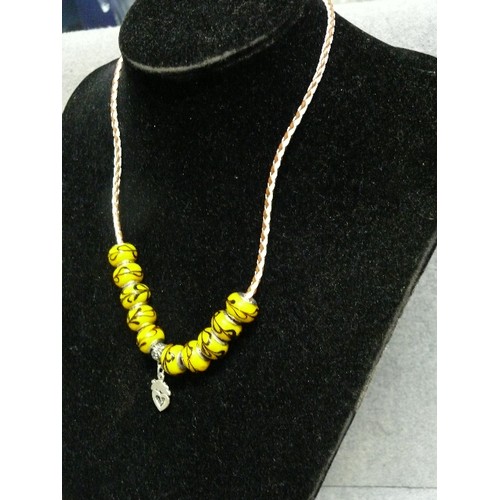 65 - A LOVELY LEATHER CHARM NECKLACE WITH  YELLOW MARBLED BEADS MARKED 925