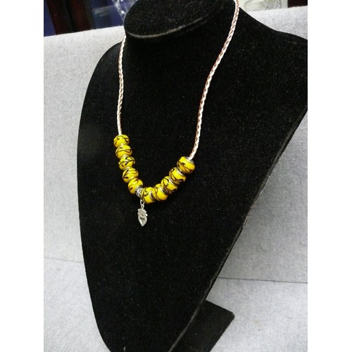 65 - A LOVELY LEATHER CHARM NECKLACE WITH  YELLOW MARBLED BEADS MARKED 925