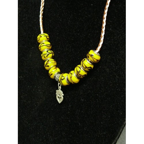 65 - A LOVELY LEATHER CHARM NECKLACE WITH  YELLOW MARBLED BEADS MARKED 925