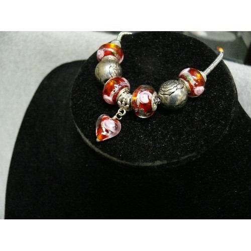 64 - A LOVELY PINK AND RED CHARM BRACELET WITH GLASS BEADS MARKED 925