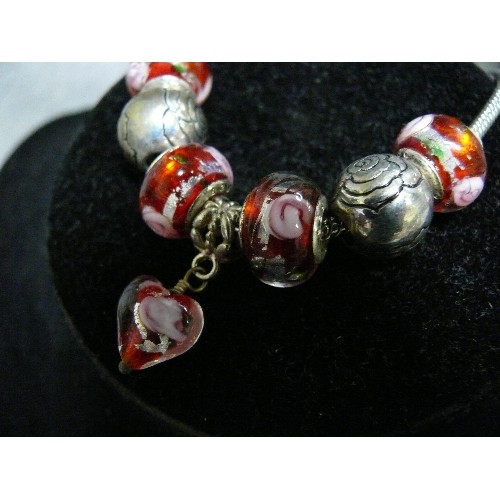 64 - A LOVELY PINK AND RED CHARM BRACELET WITH GLASS BEADS MARKED 925