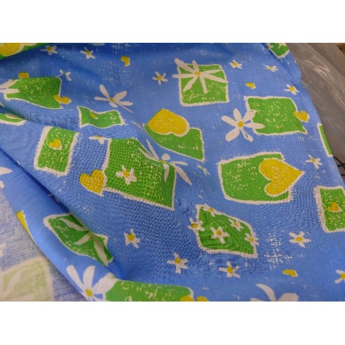 205 - A LARGE ROLL OF BLUE FABRIC WITH GREEN AND YELLOW FLORAL PATTERN