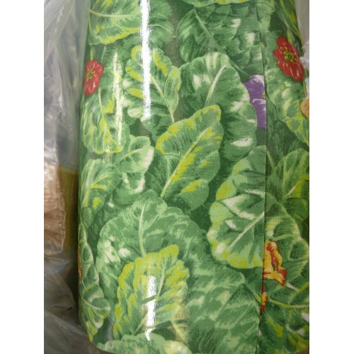 215 - A LARGE ROLL OF GREEN FLORAL VINYL FABRIC