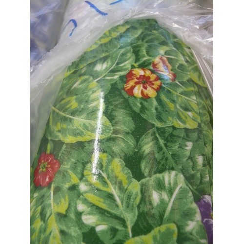 215 - A LARGE ROLL OF GREEN FLORAL VINYL FABRIC