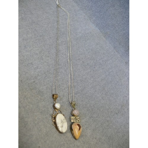 49 - TWO SILVER HEAVY PENDANTS WITH A PINK CRYSTAL AND STONE THE OTHER A PEARL AND STONE BOTH ON SILVER C... 