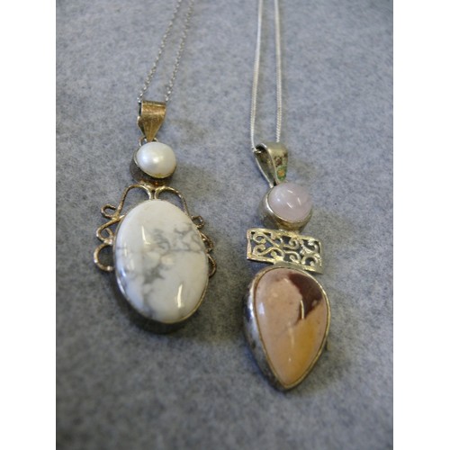 49 - TWO SILVER HEAVY PENDANTS WITH A PINK CRYSTAL AND STONE THE OTHER A PEARL AND STONE BOTH ON SILVER C... 