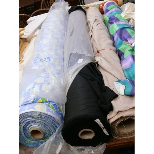 206 - A LARGE ROLL OF BLACK SILKY FABRIC