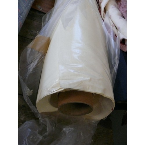 243 - A LARGE ROLL OF CREAM COLOURED VINYL MATERIAL