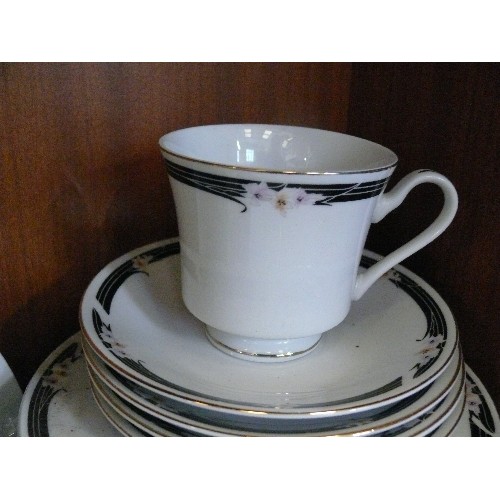 294 - FINE CHINA TEASET IN WHITE WITH  PATTERN AROUND THE EDGING BLACK WITH PASTEL FLOWERS