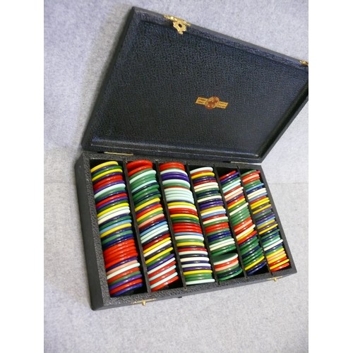 62 - A LARGE COLLECTION OF GAMING CHIPS HELD IN A WOODEN ROTARY STAND AND A SMALL LEATHER CASE