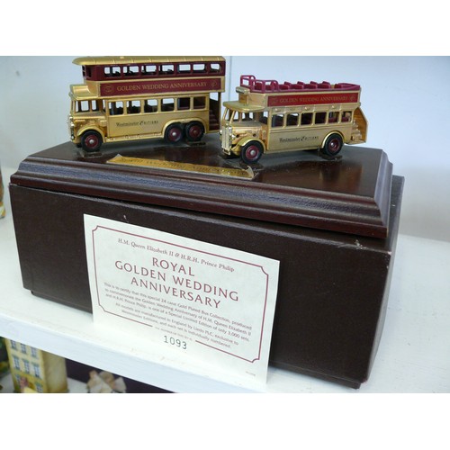 87 - 2 DIECAST LLEDO GOLD COLOURED ROYAL WEDDING ANNIVERSARY BUSES ON PLINTH