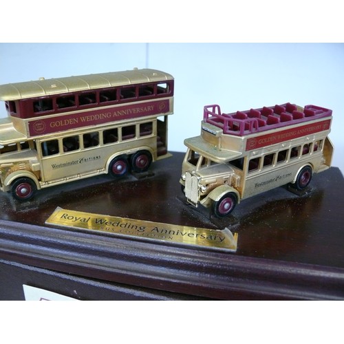 87 - 2 DIECAST LLEDO GOLD COLOURED ROYAL WEDDING ANNIVERSARY BUSES ON PLINTH