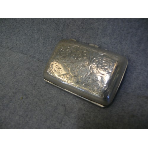 18 - Sterling Silver Cigarette Case, with engraved foliate scroll design, diamond cartouche with 