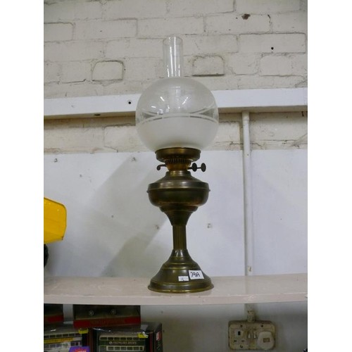 79A - A LARGE BRASS BASED OIL LAMP WITH GLASS FUNNEL AND SHADE