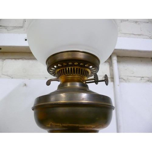 79A - A LARGE BRASS BASED OIL LAMP WITH GLASS FUNNEL AND SHADE