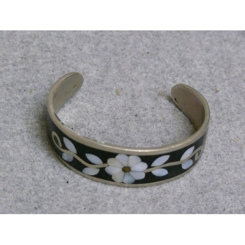 13 - A SOLID SILVER BANGLE WITH BLACK ENAMEL WITH MOTHER OF PEARL SET IN