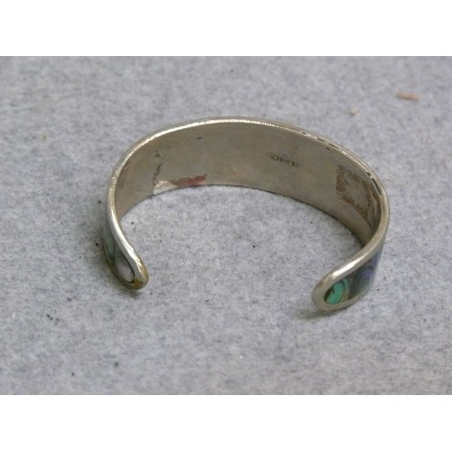 13 - A SOLID SILVER BANGLE WITH BLACK ENAMEL WITH MOTHER OF PEARL SET IN