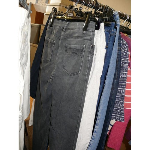 387 - A QUANTITY OF EXCELLENT QUALITY LADIES CLOTHES TO INCLUDE JEANS, CORDS, TOPS, DASH, JOHN LEWIS, M&S