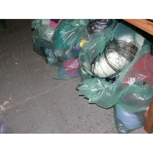 390 - A LARGE QUANTITY OF BAGS OF CLOTHING