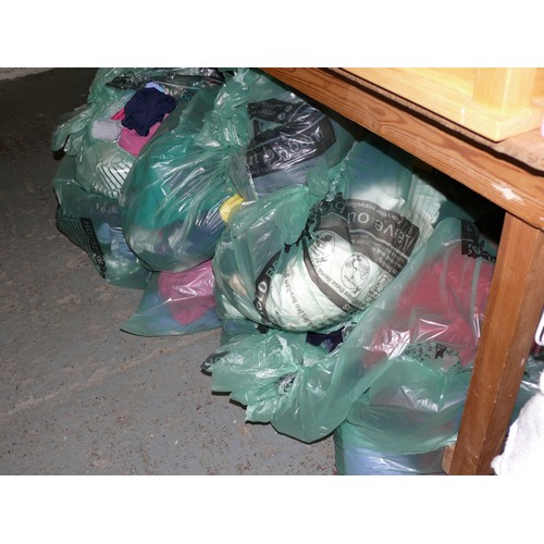 390 - A LARGE QUANTITY OF BAGS OF CLOTHING