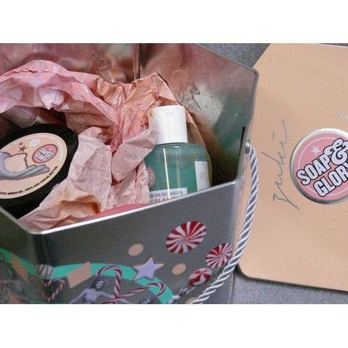 68 - A VERY NICE SOAP & GLORY GIFT SET IN A LARGE TIN PLUS 3 BOXES OF VARIOUS TOILETRIES AND COSMETICS