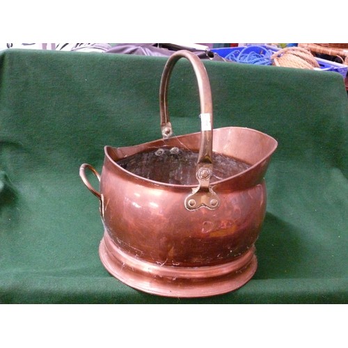 119 - A LARGE COPPER HELMET COAL SCUTTLE WITH BRASS HANDLE