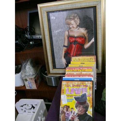 144 - A SELECTION OF MRS BROWN'S BOYS DVDS AND A FRAMED AND GLAZED SAUCY PICTURE OF THE LOVELY AGNES BROWN