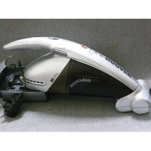 153 - A HANDHELD HOOVER VACUUM CLEANER WITH A CORDED WALL MOUNTED HOLDER