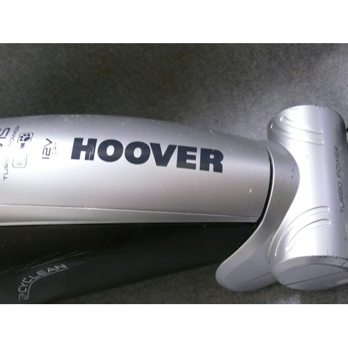 153 - A HANDHELD HOOVER VACUUM CLEANER WITH A CORDED WALL MOUNTED HOLDER