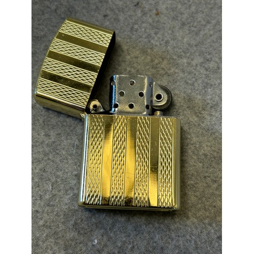 17 - A RONSON GOLD METAL LIGHTER IN THE STYLE OF ZIPPO