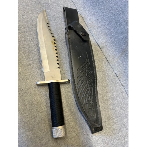 14 - A SURVIVAL OR HUNTING KNIFE,  8.5 INCH BLADE WHICH HAS SERRATED BACK EDGE FOR LOG CUTTING, INSIDE HI... 