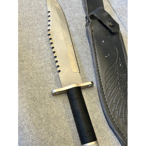 14 - A SURVIVAL OR HUNTING KNIFE,  8.5 INCH BLADE WHICH HAS SERRATED BACK EDGE FOR LOG CUTTING, INSIDE HI... 