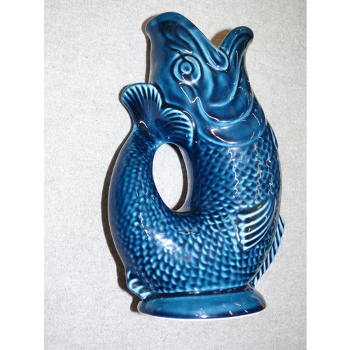 73 - A BLUE CERAMIC GLUGGLE JUG BY DARTMOUTH POTTERY