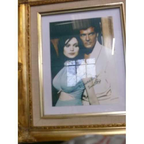 138 - FRAMED AND GLAZED JAMES BOND ROGER MOORE AND MADELINE SMITH PHOTOGRAPH SIGNED BY MADELINE SMITH