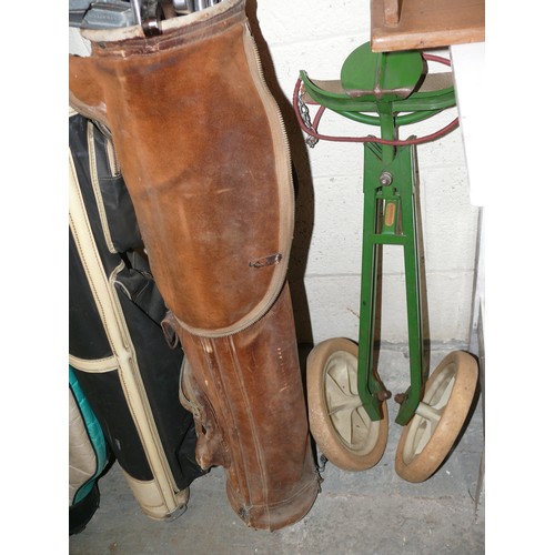 269 - 3 GOLF BAGS FULL OF VINTAGE GOLF CLUBS AND A SET OF CADDY WHEELS.