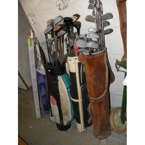 269 - 3 GOLF BAGS FULL OF VINTAGE GOLF CLUBS AND A SET OF CADDY WHEELS.