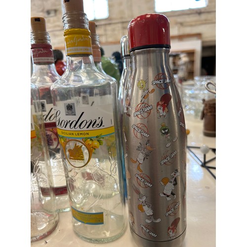 354 - SEVERAL GORDONS GIN BOTTLES, A RED GLASS ONEWITH LED LIGHTS INSIDE AND 2 WATER FLASKS
 TWO WATER FLA... 