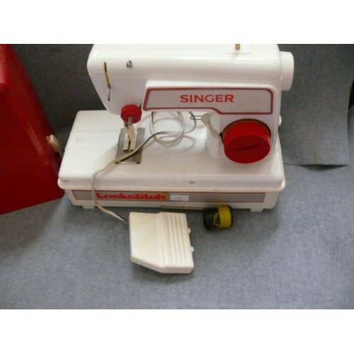 369 - CHILD'S LOCKSTITCH SEWING MACHINE IN RED CASE.