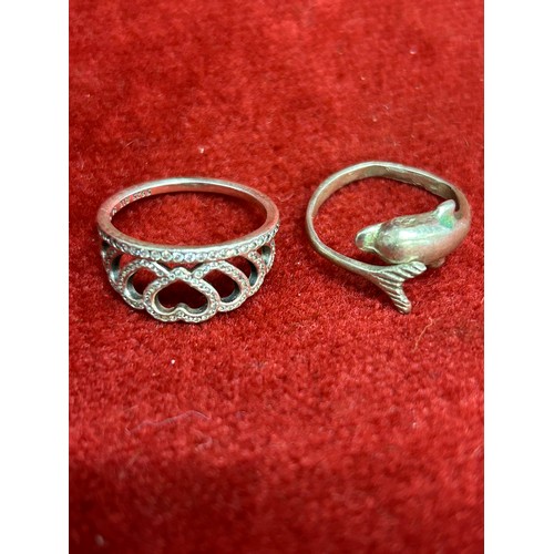 34 - TWO SILVER RINGS 1 A CROWN WITH DIAMANTE THE OTHER A DOLPHIN