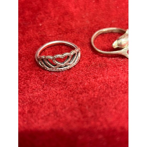 34 - TWO SILVER RINGS 1 A CROWN WITH DIAMANTE THE OTHER A DOLPHIN