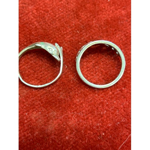 34 - TWO SILVER RINGS 1 A CROWN WITH DIAMANTE THE OTHER A DOLPHIN