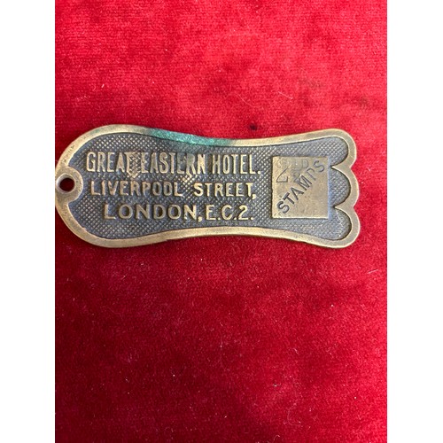 12 - A VINTAGE BRASS KEY RETURN KEY FOB  FROM THE RAILWAYS GREAT EASTERN HOTEL WITH PREPAID 2.5 PENCE STA... 