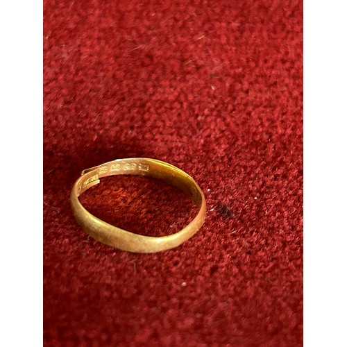 8 - A 22 carat gold wedding band - cut & worn, London hallmark. 1.4 grams