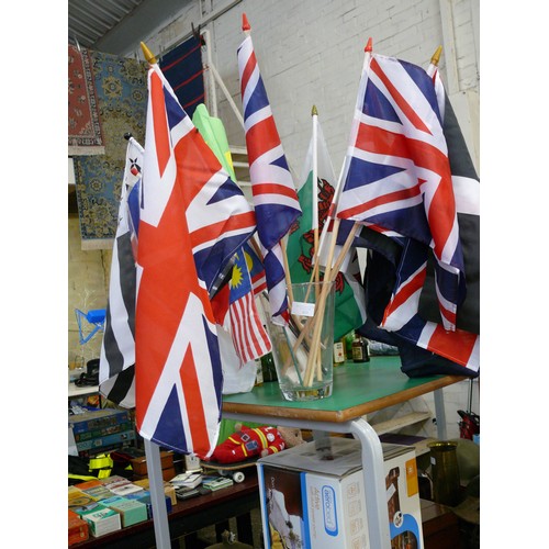 333 - COLLECTION OF SMALL FLAGS ON WOODEN DOWEL. INC UNION JACK, CORNISH FLAG, WELSH ETC.